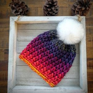 Sunset colored beanie with white, fluffy pompom